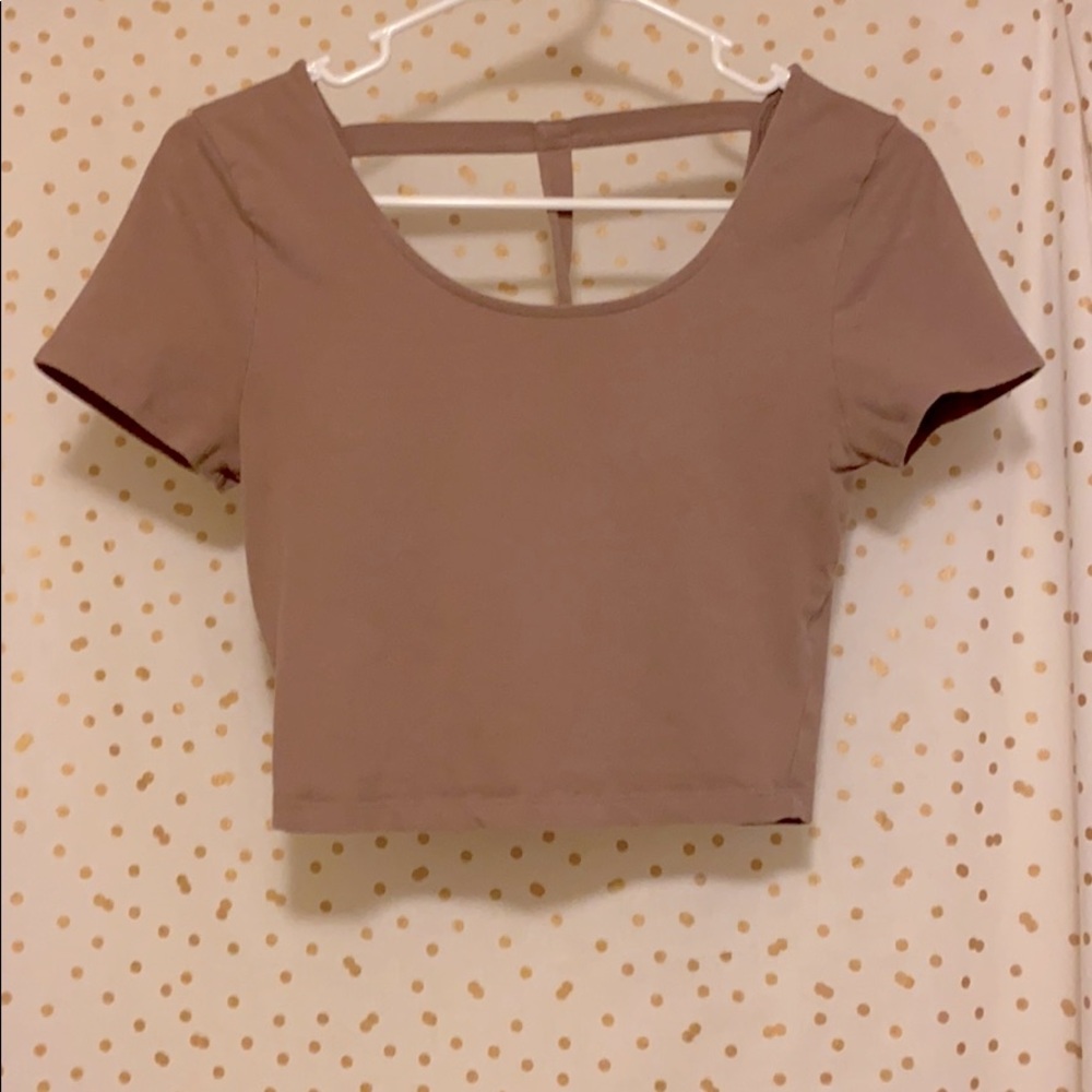 Light pink crop top with strap on back.